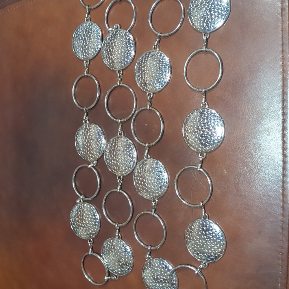 Silver tone medallions and circle belt